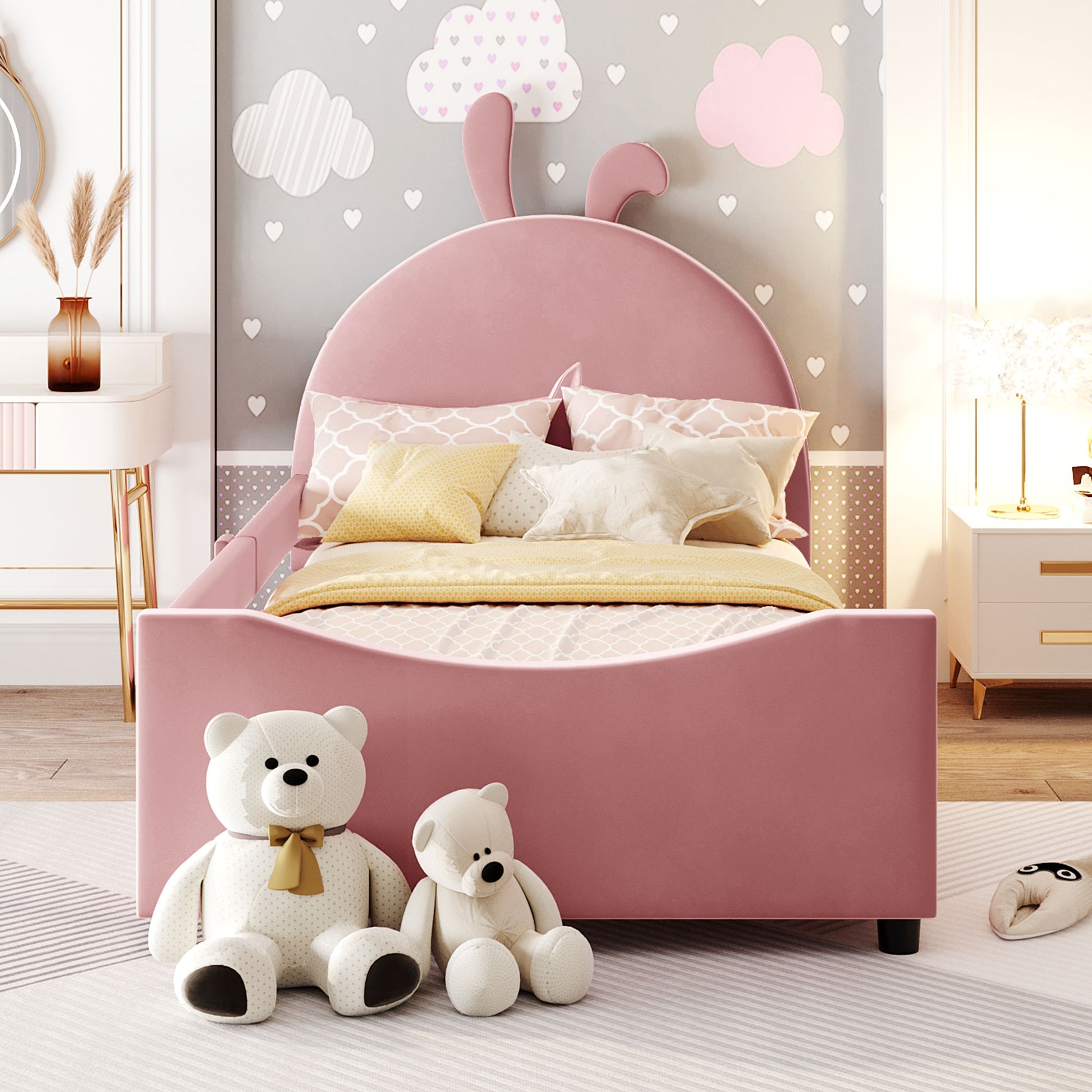Pink velvet twin bed with bunny ears headboard and decorative pillows
