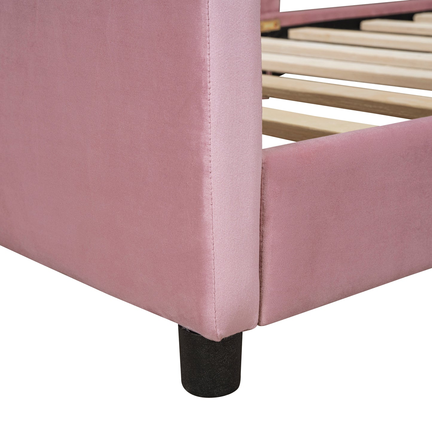 Pink velvet upholstered bed frame showing side and slats