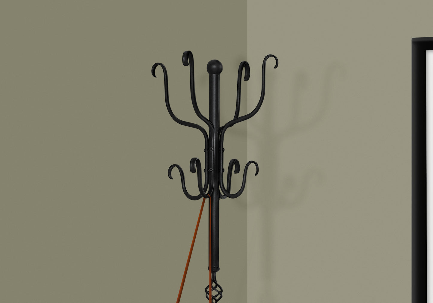 Black wrought iron coat rack with decorative scrollwork