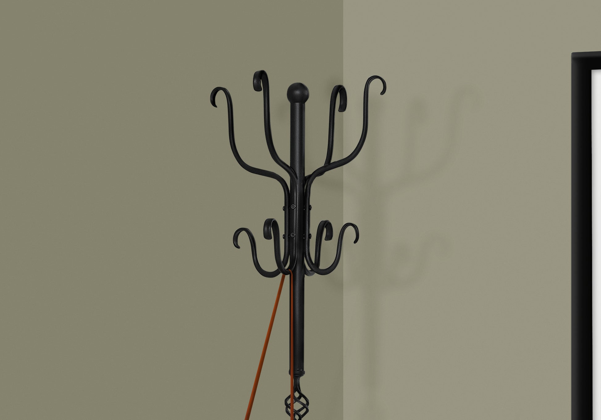 Black wrought iron coat rack with decorative scrollwork