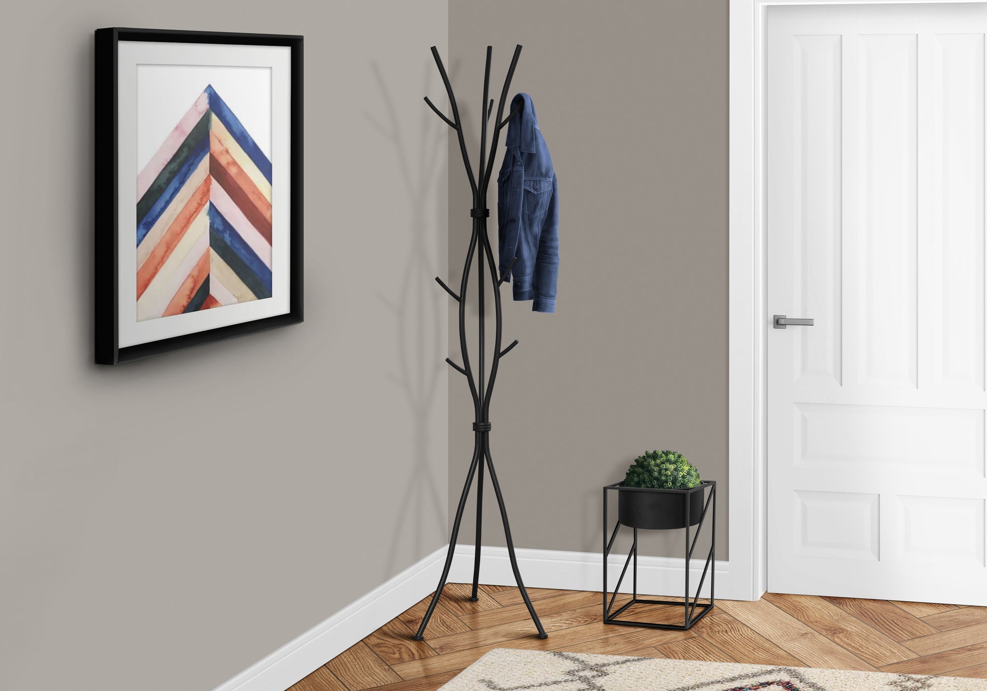 Black metal floor coat rack with denim jacket hanging