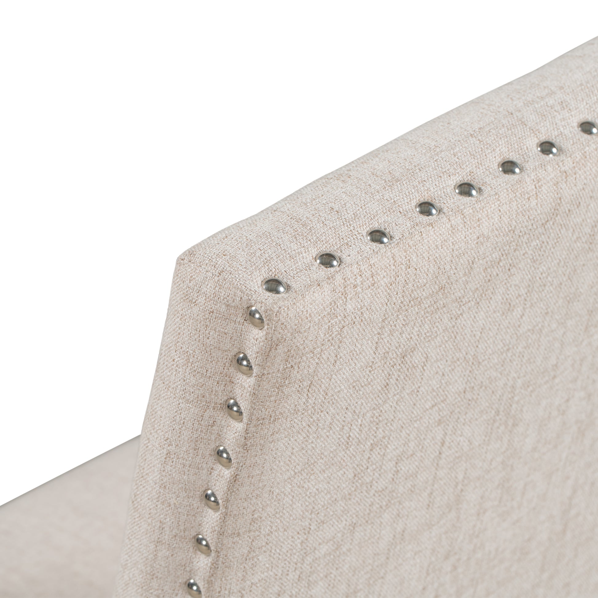 Closeup of beige linen fabric with decorative nailhead trim