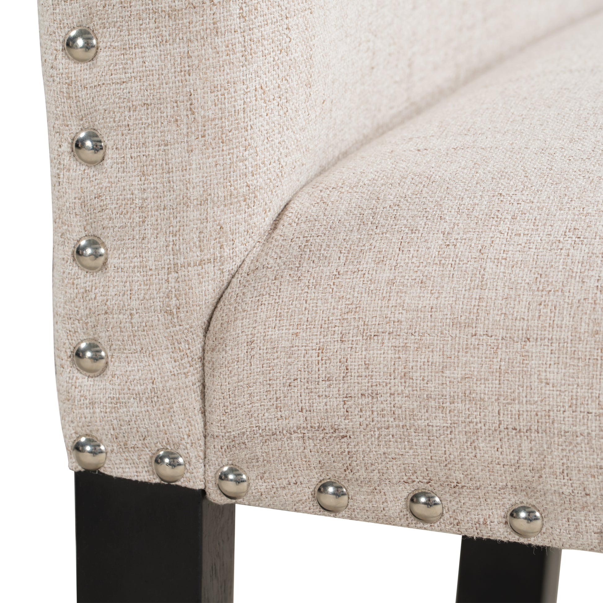 Beige textured upholstered chair with silver nailhead trim