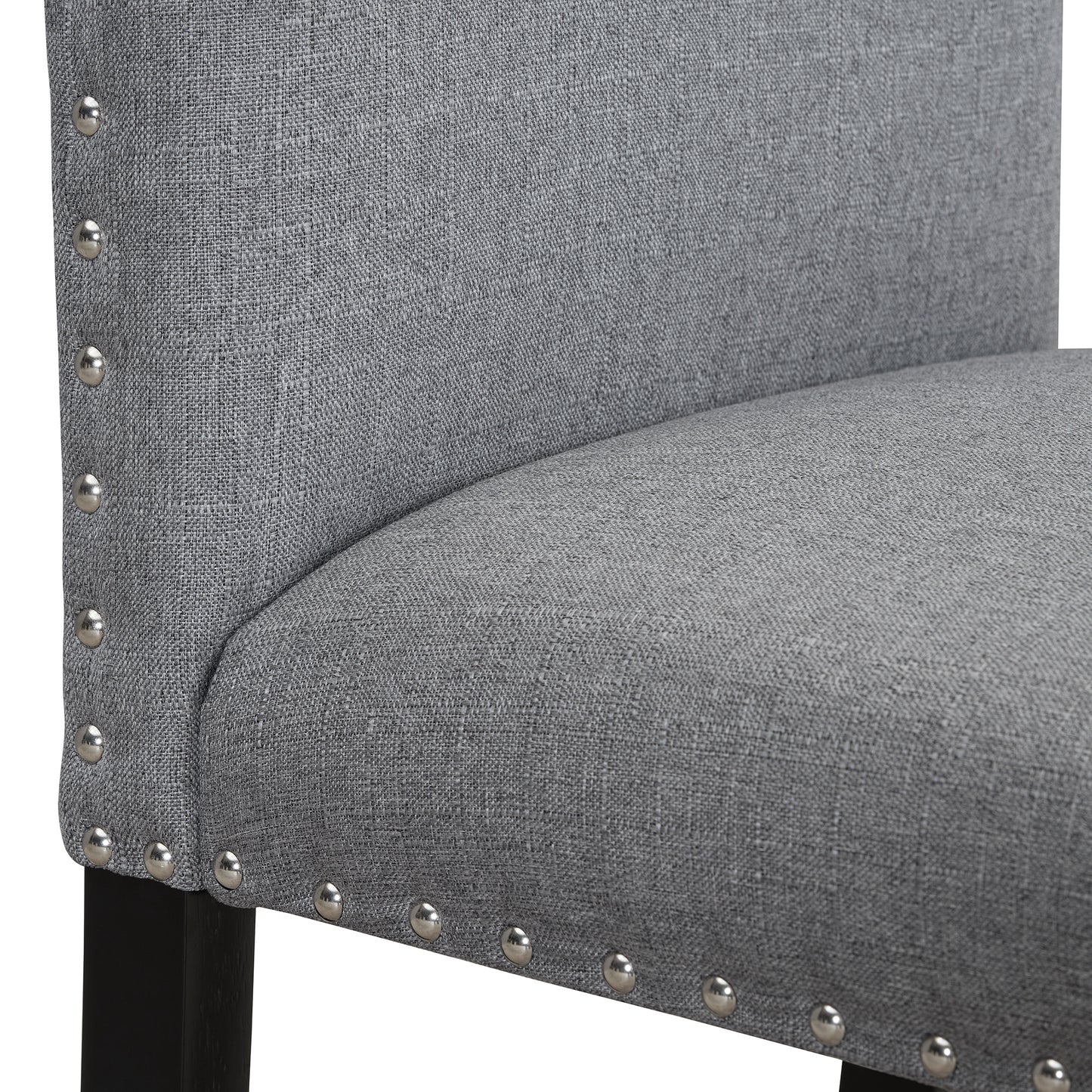 Gray linen upholstered dining chair with silver nailhead trim and black wooden legs