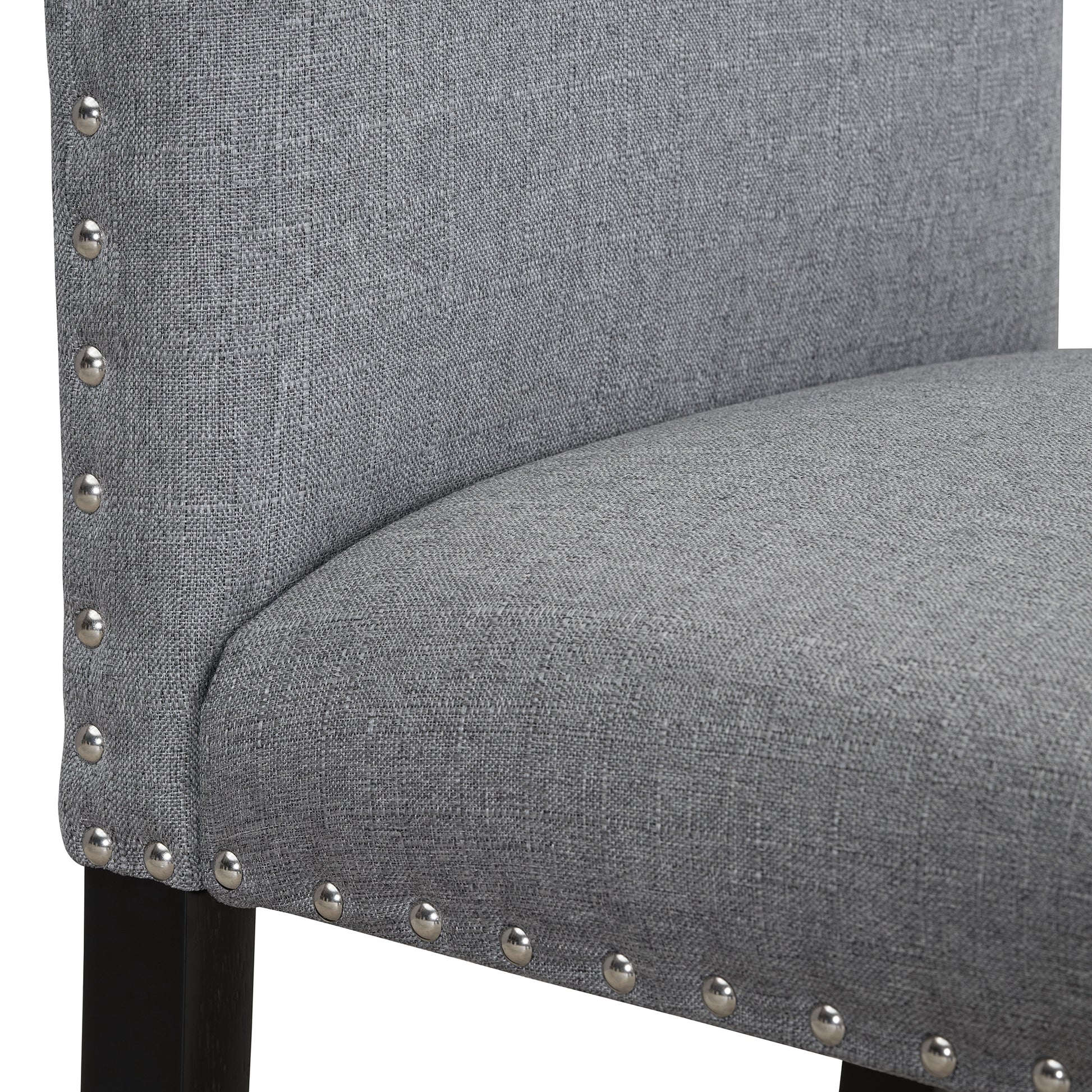 Gray linen upholstered dining chair with silver nailhead trim and black wooden legs