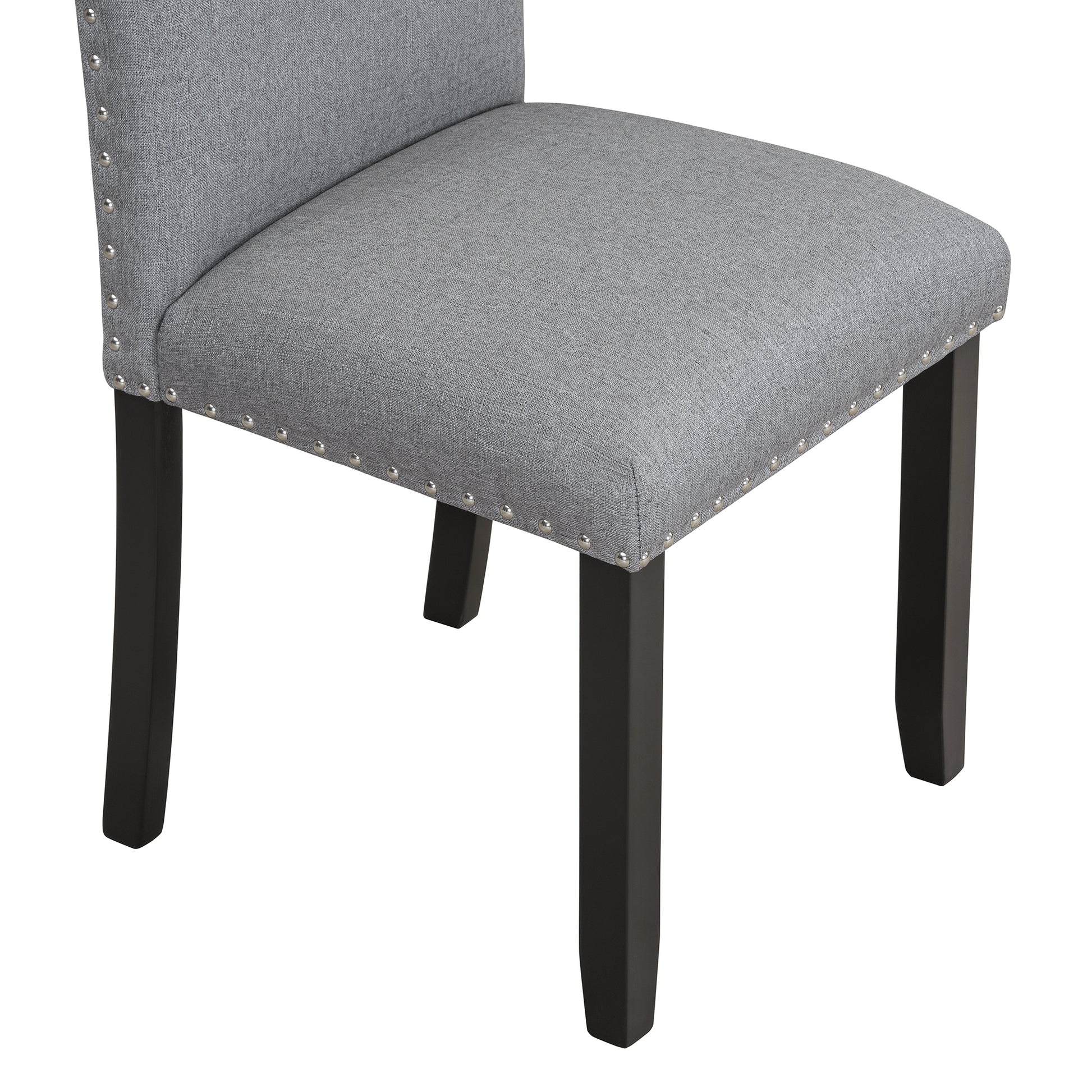Gray upholstered dining chair with silver nailhead trim and dark wood legs