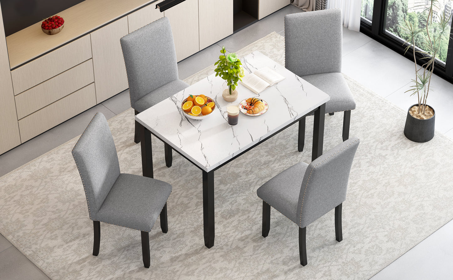 Grey upholstered dining chair with nailhead trim and dark wood legs