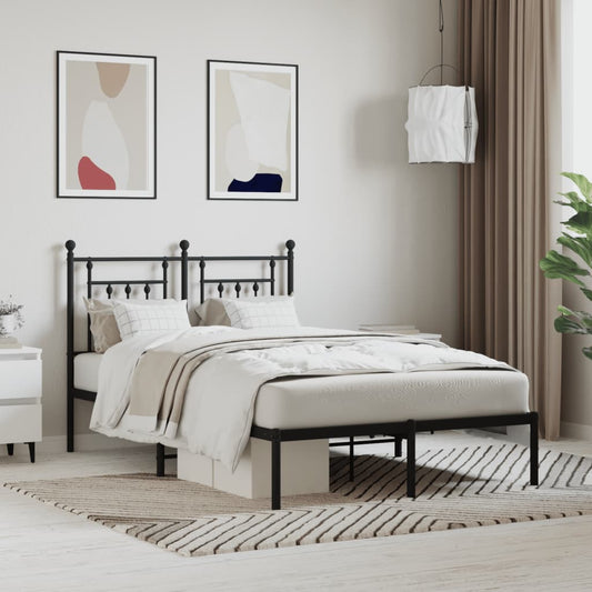Bronze metal queen bed frame with decorative finials and a patterned comforter