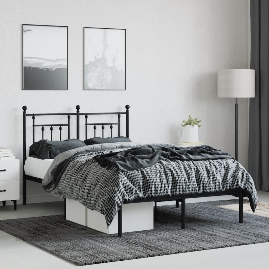 Black metal twin bed frame with ornate headboard