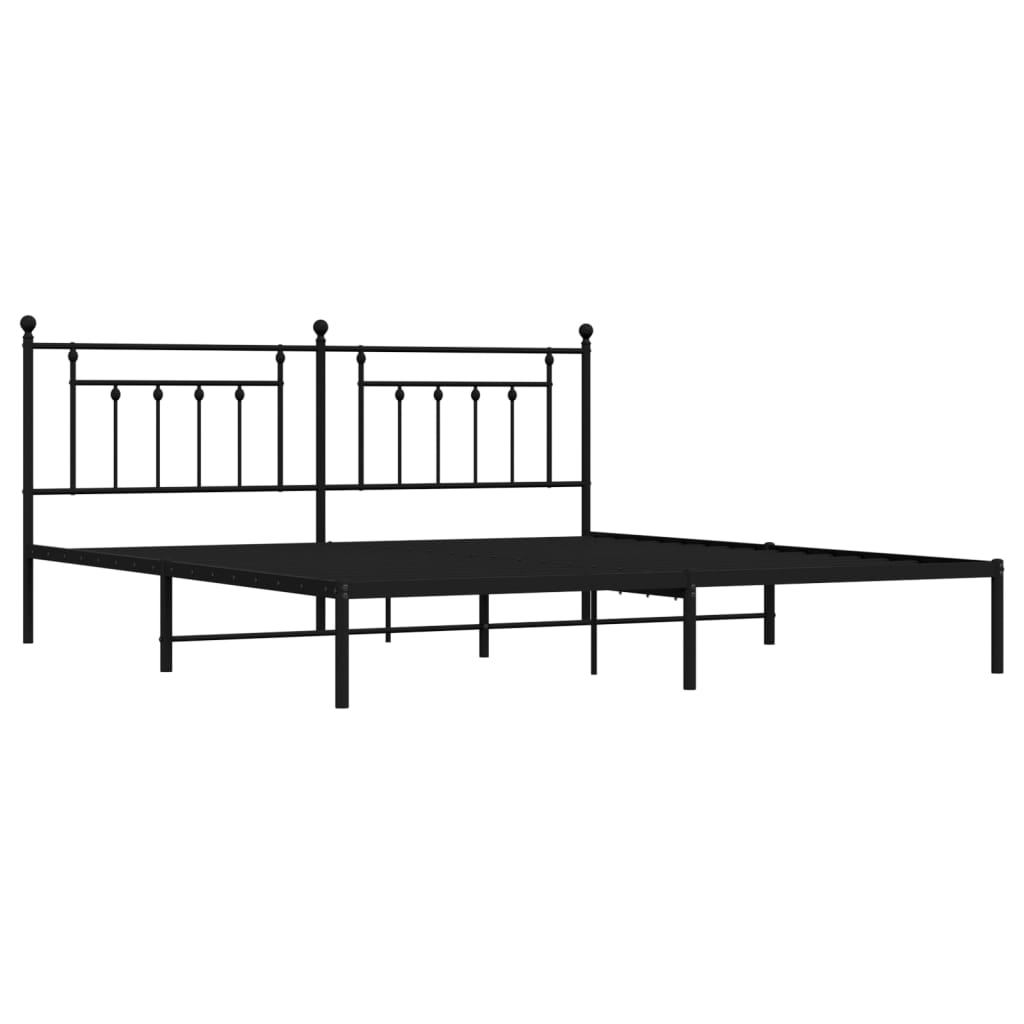 Black metal bed frame with ornate headboard and white mattress