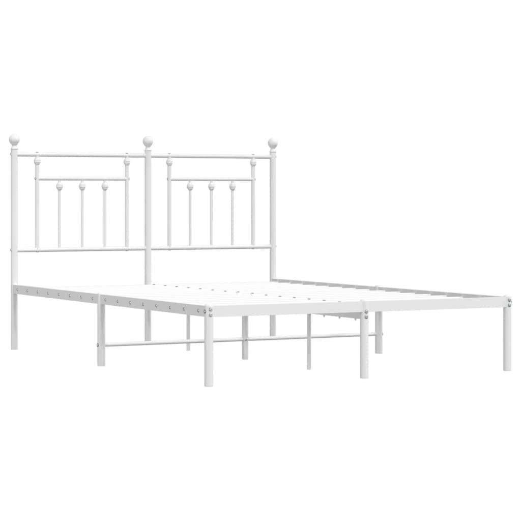 White metal bed frame with ornate headboard and mattress