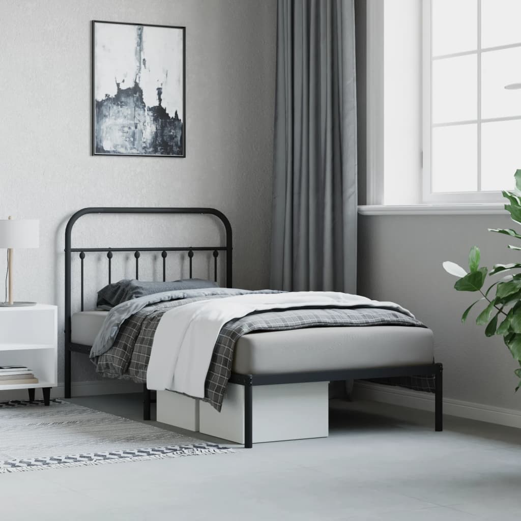 Black metal twin bed frame with arched headboard and footboard showcasing a cozy bedroom setup