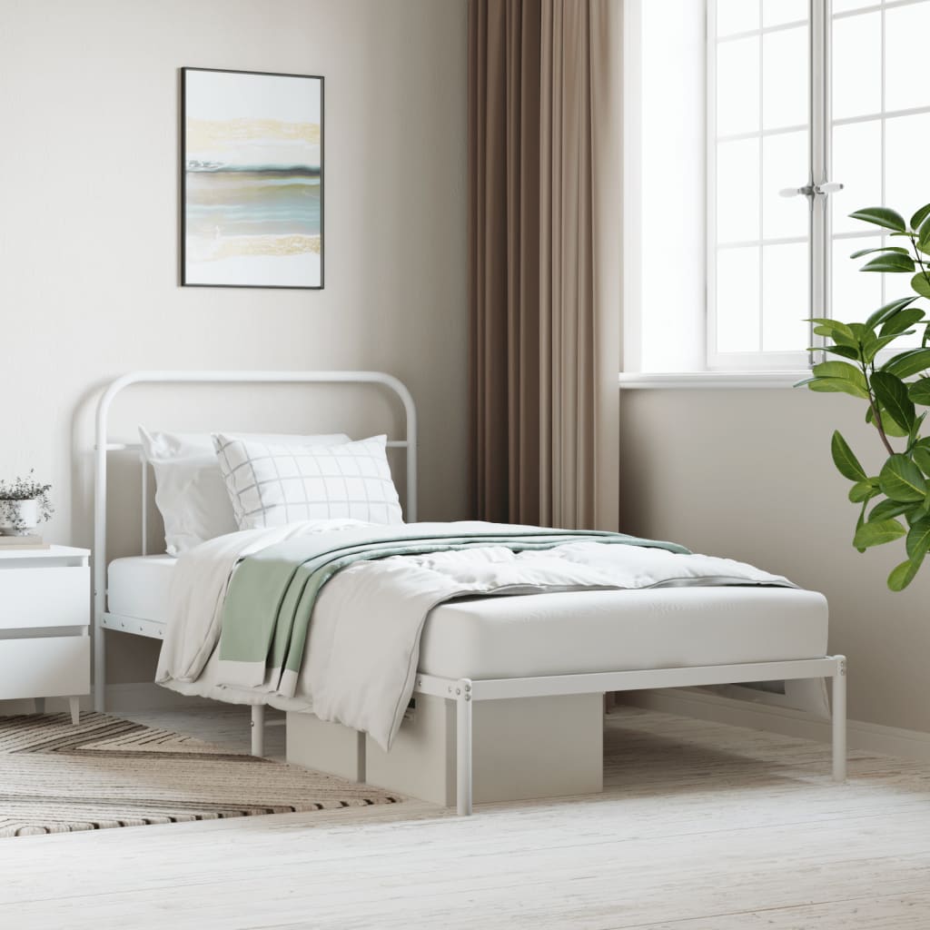 White metal twin bed frame with rounded headboard and footboard featuring a light brown herringbone throw blanket
