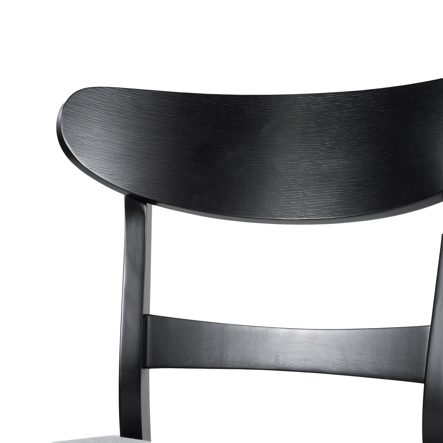 Closeup of a modern black wooden chair back with curved design