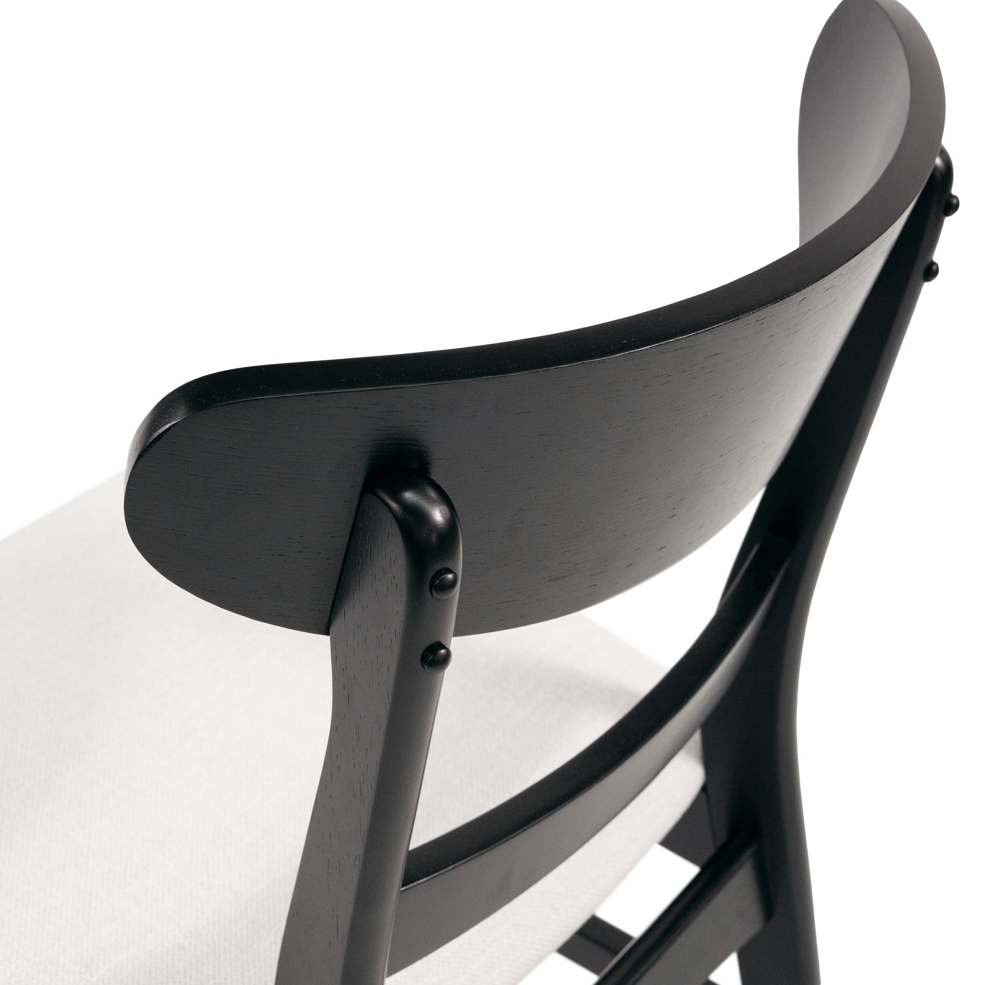 Dark wood chair with curved backrest and textured white seat