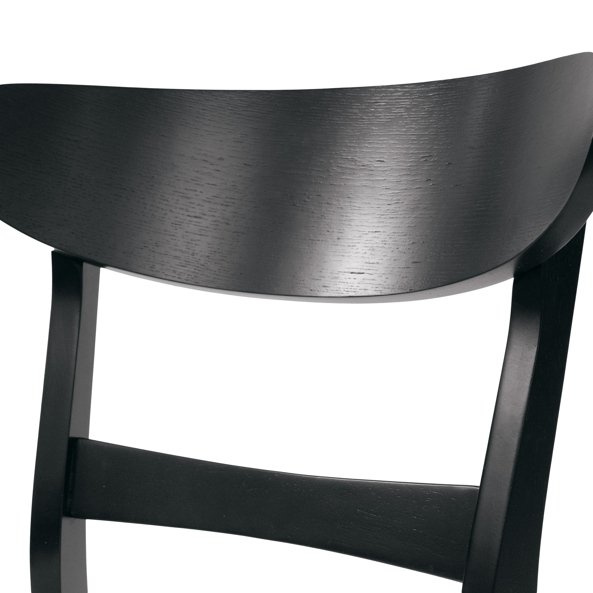 Black wooden chair backrest with curved profile and visible wood grain