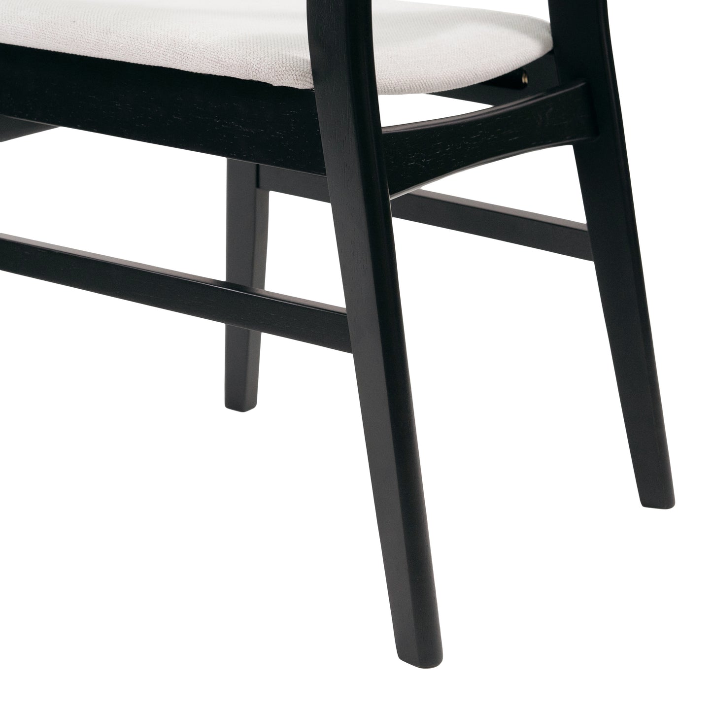 Black wooden chair legs with beige fabric seat detail