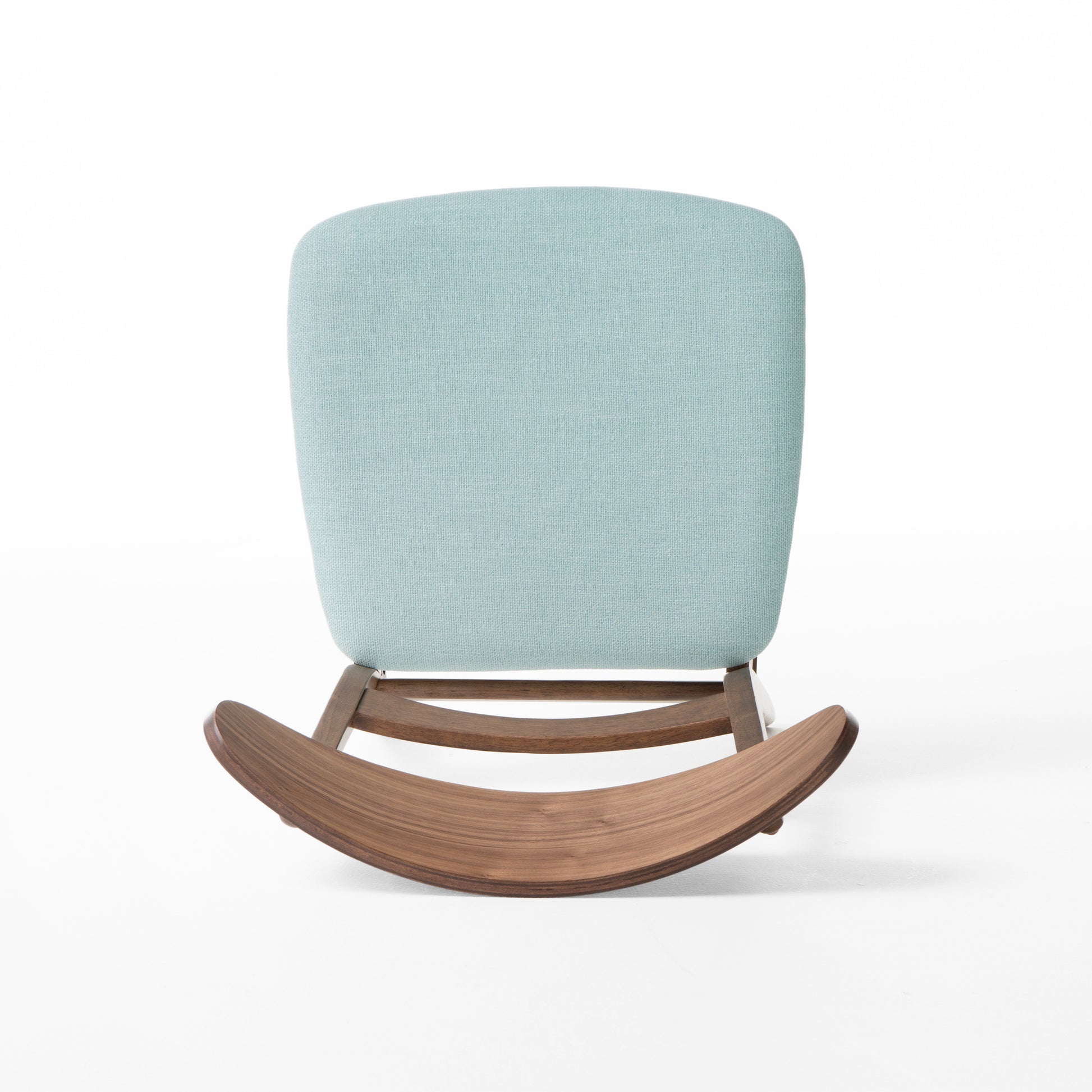 Light blue upholstered rocking chair with curved walnut wood base
