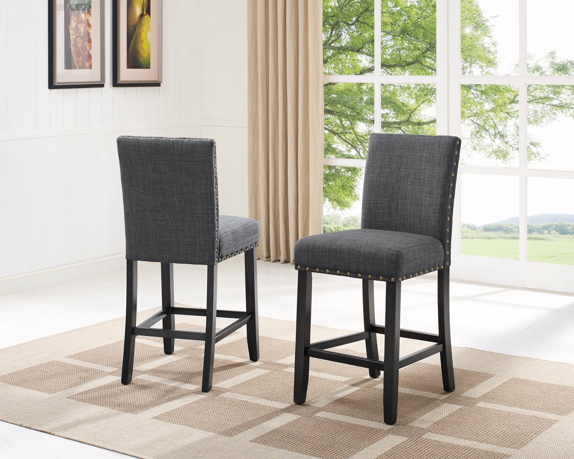 Dark gray upholstered bar stool with brass nailhead trim and black legs