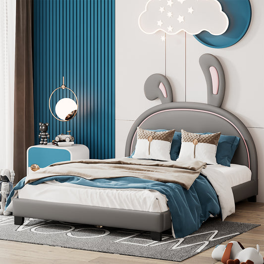 Gray upholstered kids bed with rabbit ears headboard and blue bedding