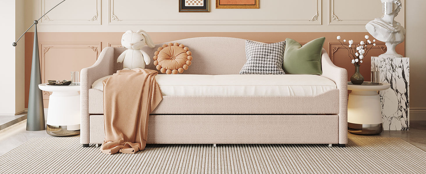 Tufted pink daybed with pullout trundle and soft throw blankets
