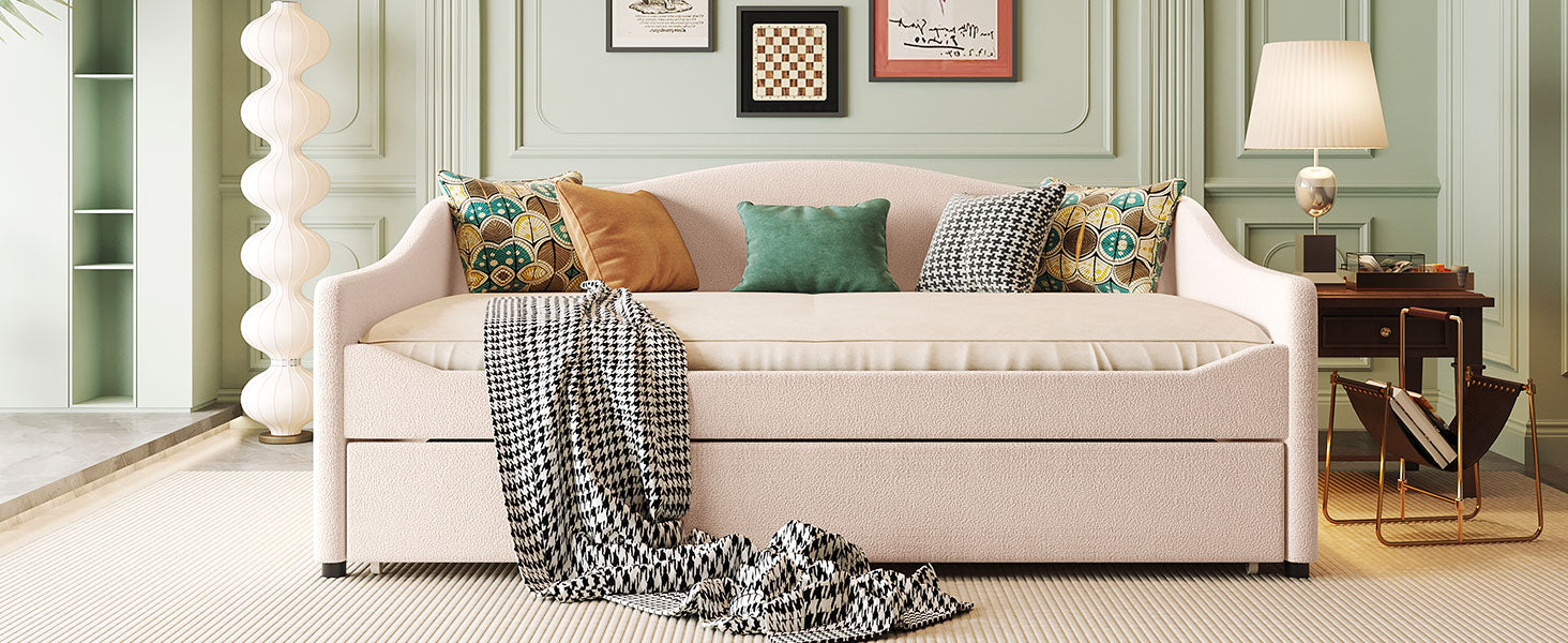 Modern pink boucle daybed with pullout trundle and decorative pillows