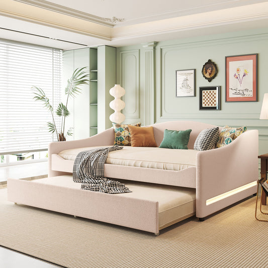 Pink upholstered daybed with trundle and decorative pillows
