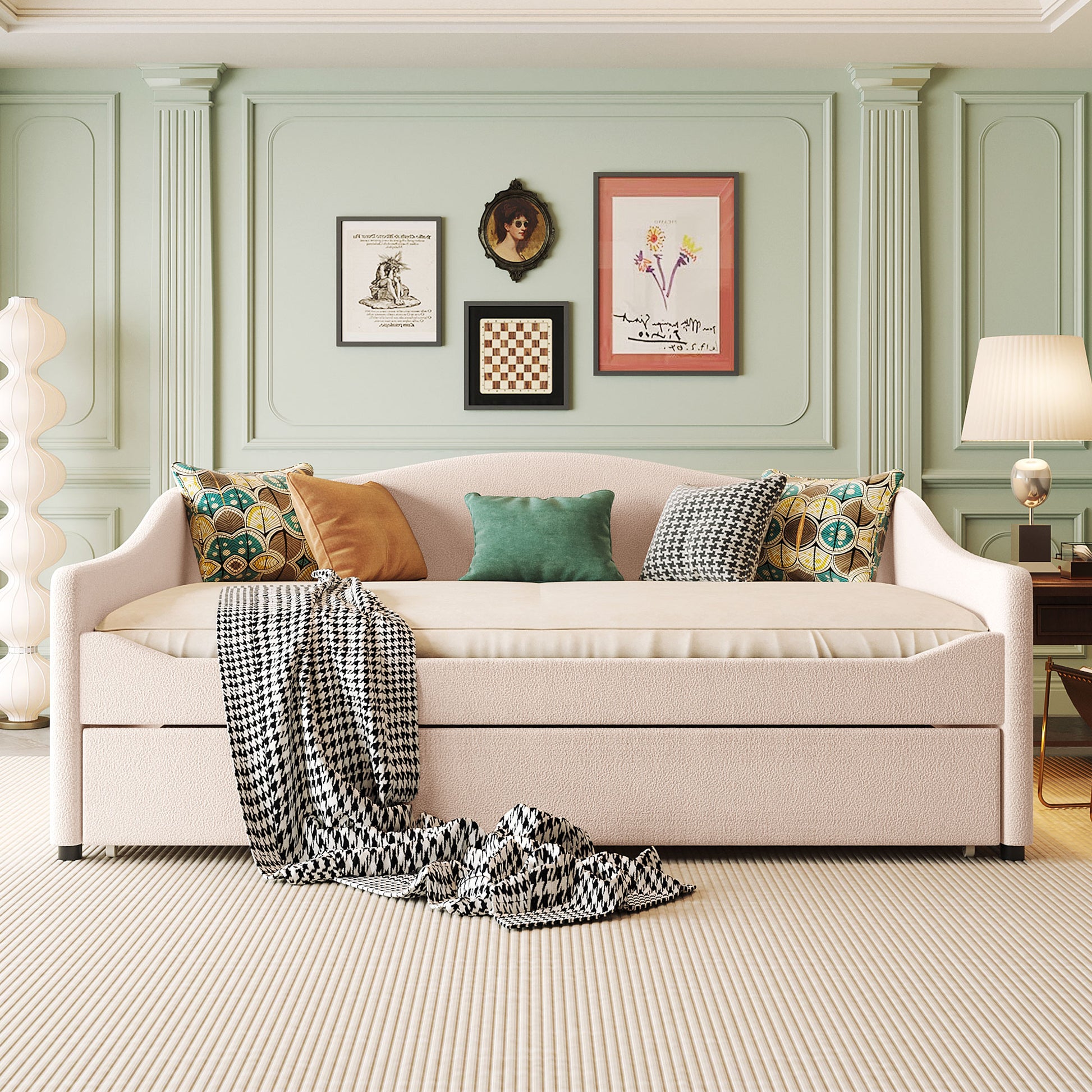 Pink boucle fabric daybed with houndstooth throw and decorative pillows