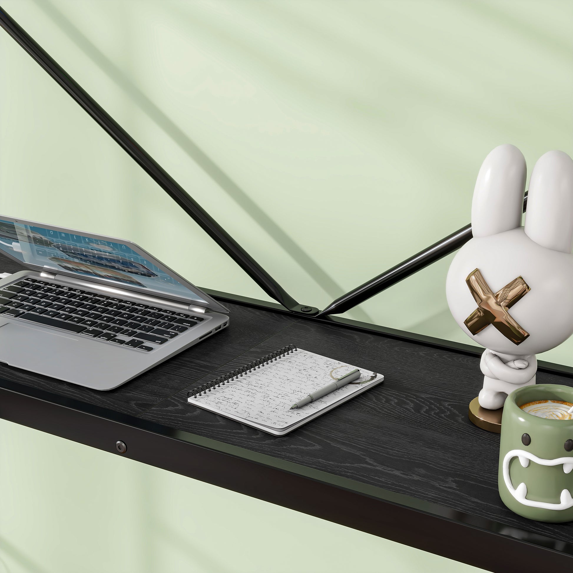 Gray silver laptop open on a black wood grain desk