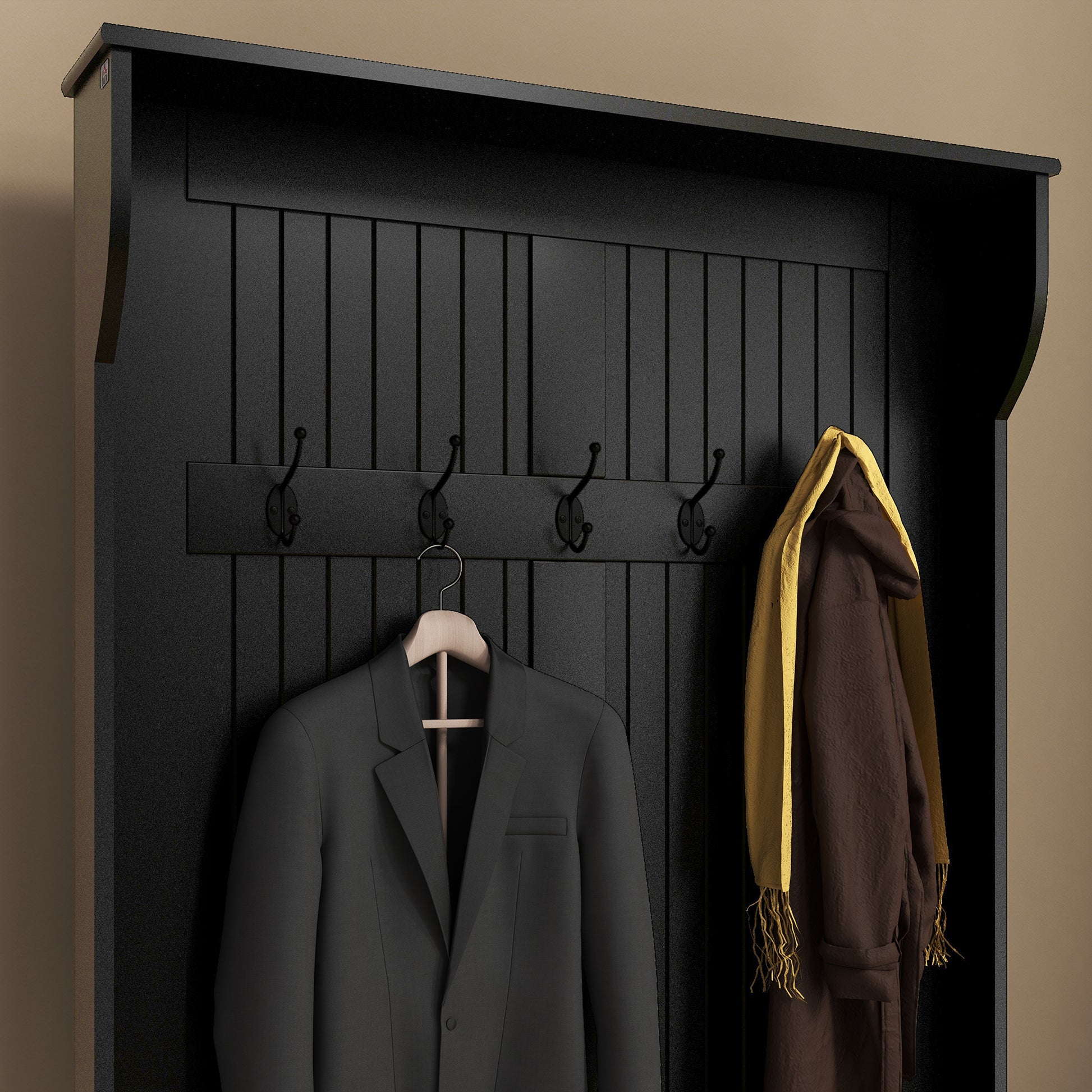 Black wooden hall tree with four metal coat hooks and garments