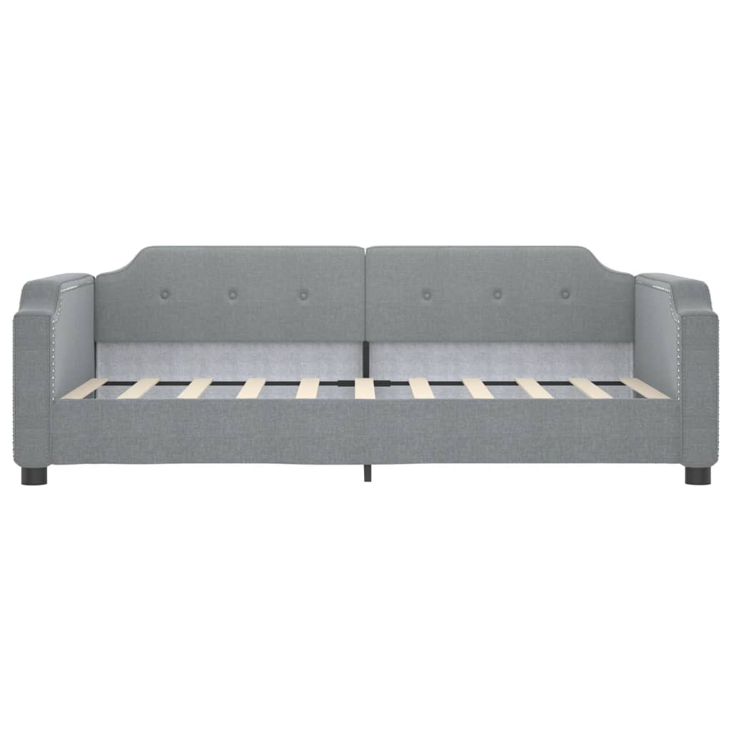 Grey fabric daybed with button tufting and nailhead trim