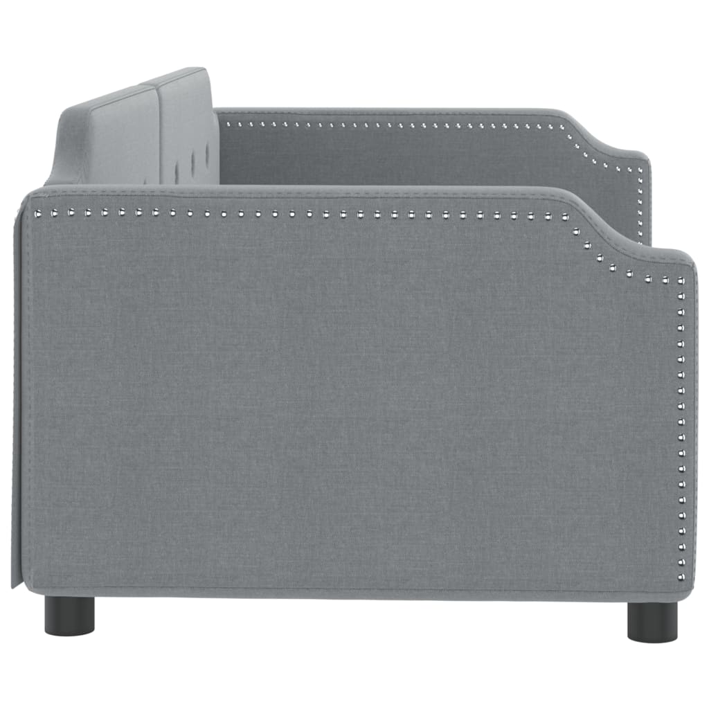 Grey upholstered daybed with tufted back and wooden slats