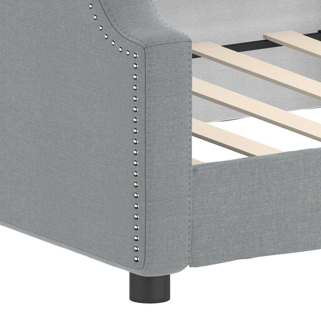 Light grey fabric sectional sofa with studded armrest detail