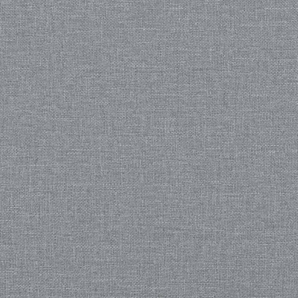 Closeup of grey upholstered twin bed frame with silver nailhead trim detail