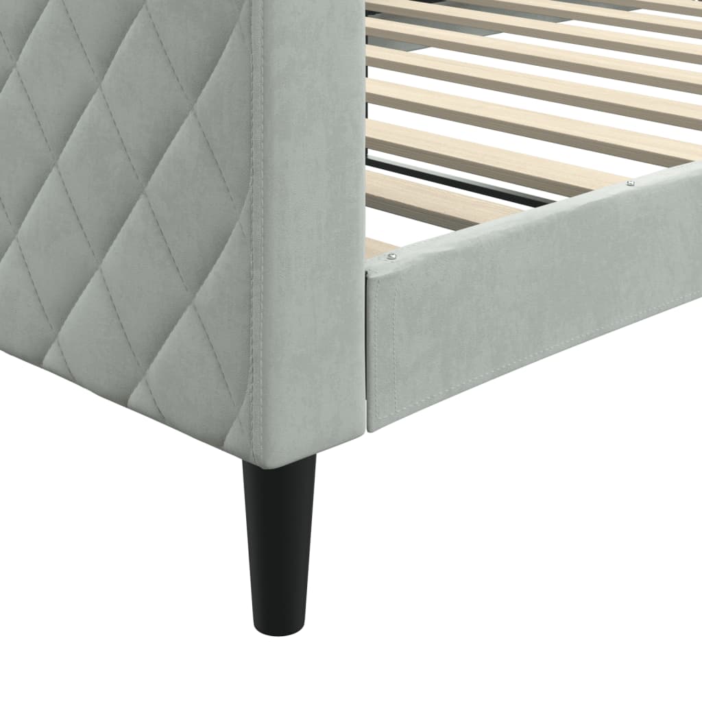 Light gray velvet sofa with diamond tufting on the left armrest and minimalist black legs