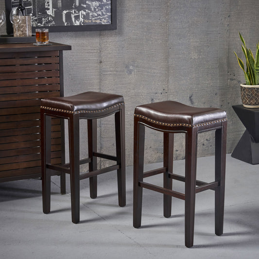Dark brown leather saddle bar stools with brass nailhead trim
