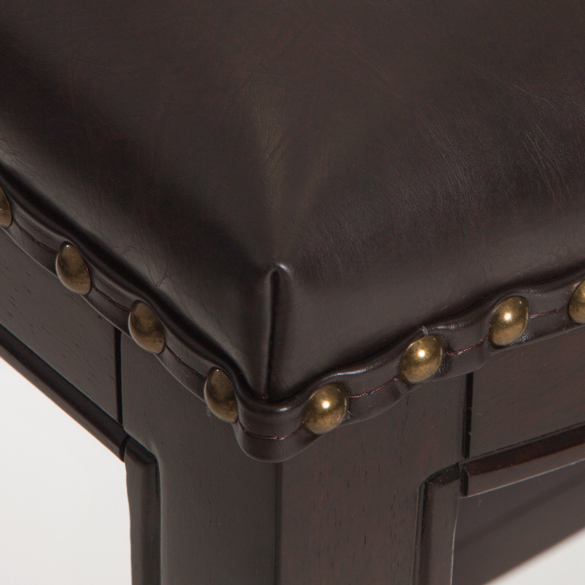 Dark brown leather bench with brass nailhead trim detail