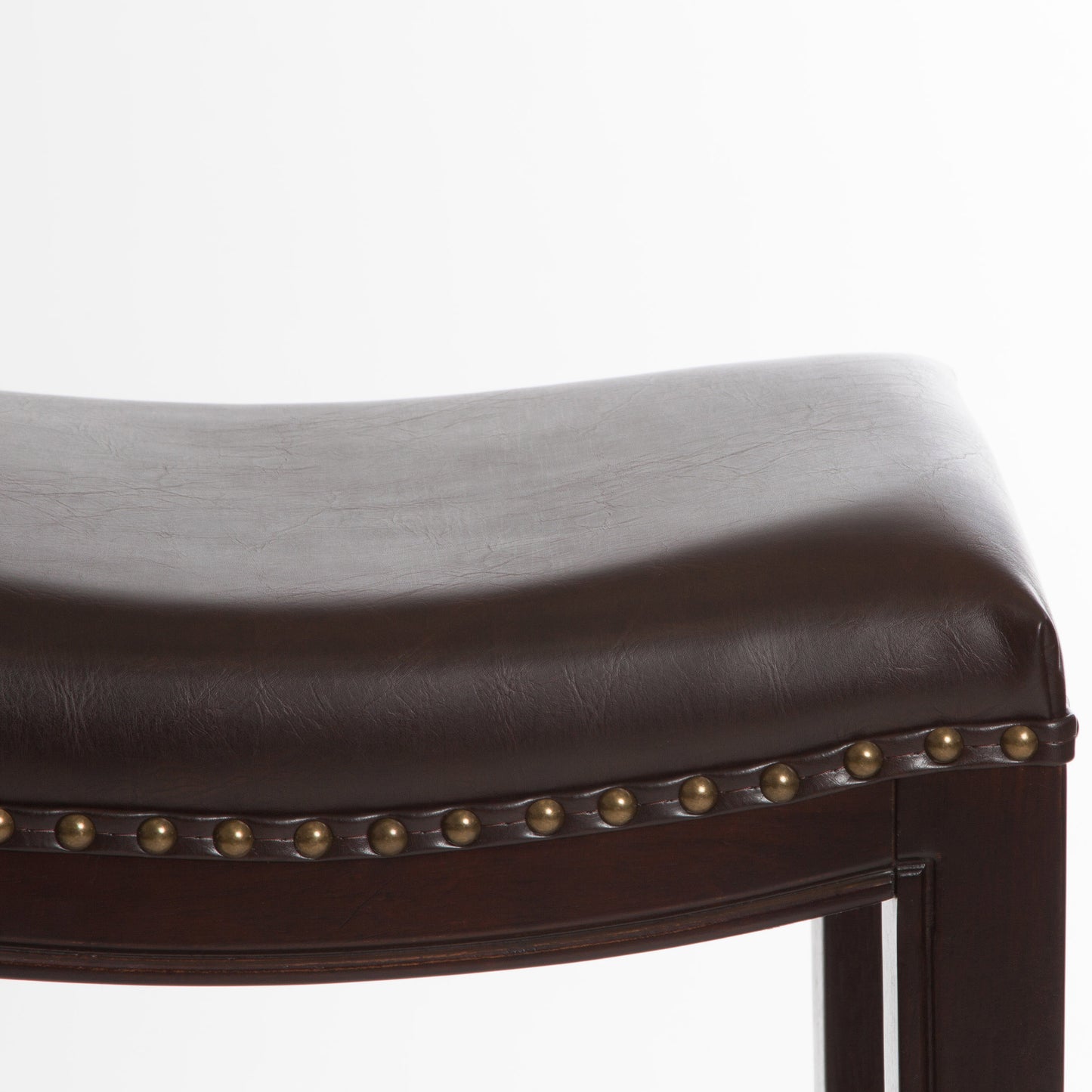 Dark brown faux leather saddle stool seat with brass nailhead trim