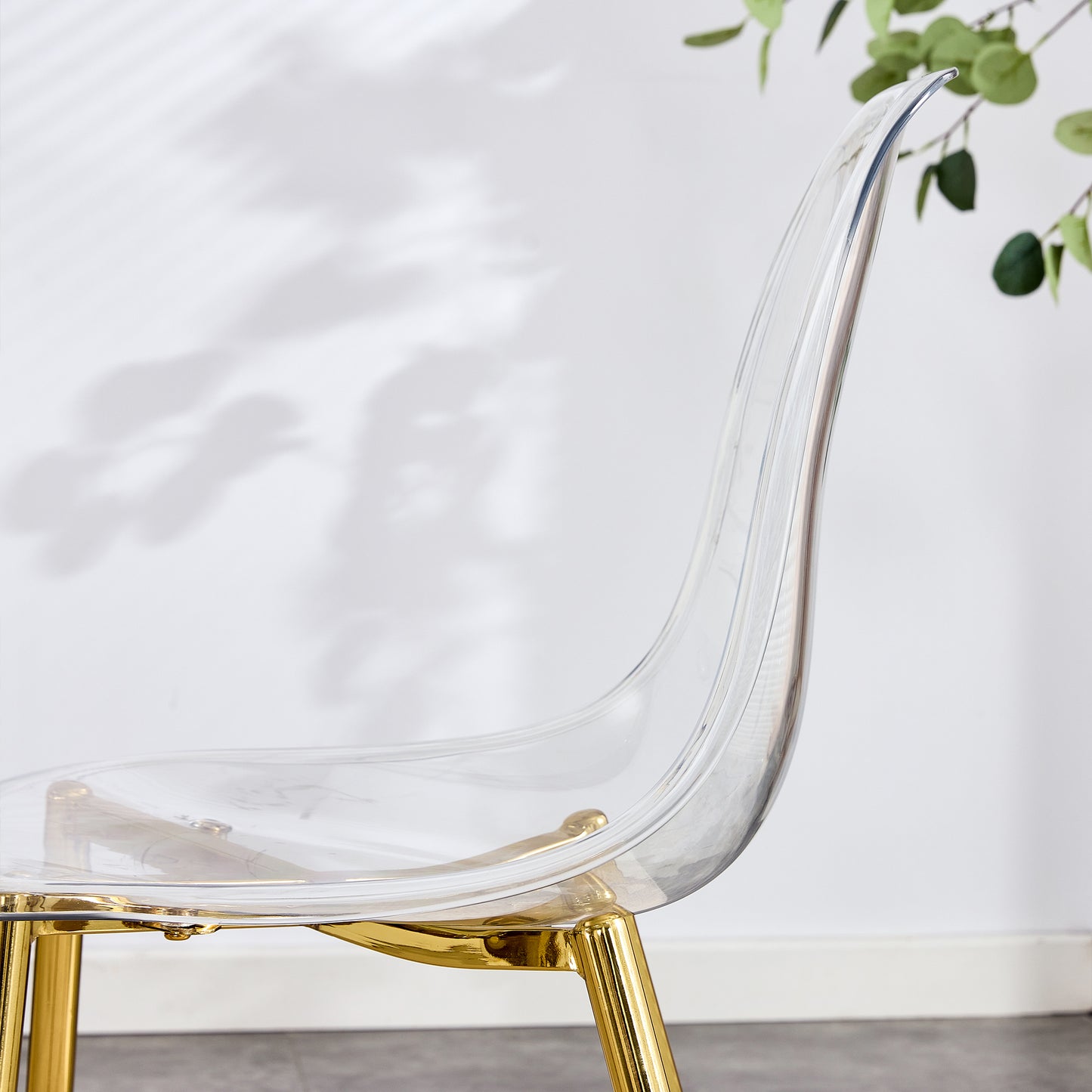 Clear acrylic dining chair with gold legs