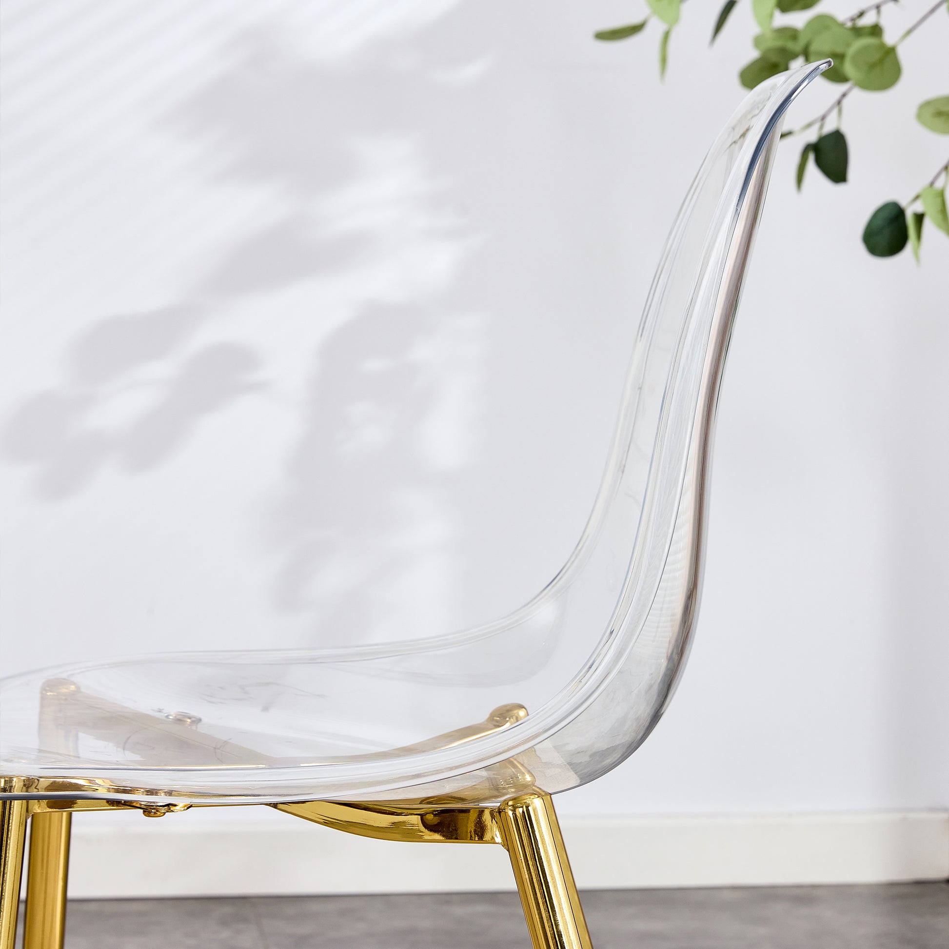 Clear acrylic dining chair with gold legs