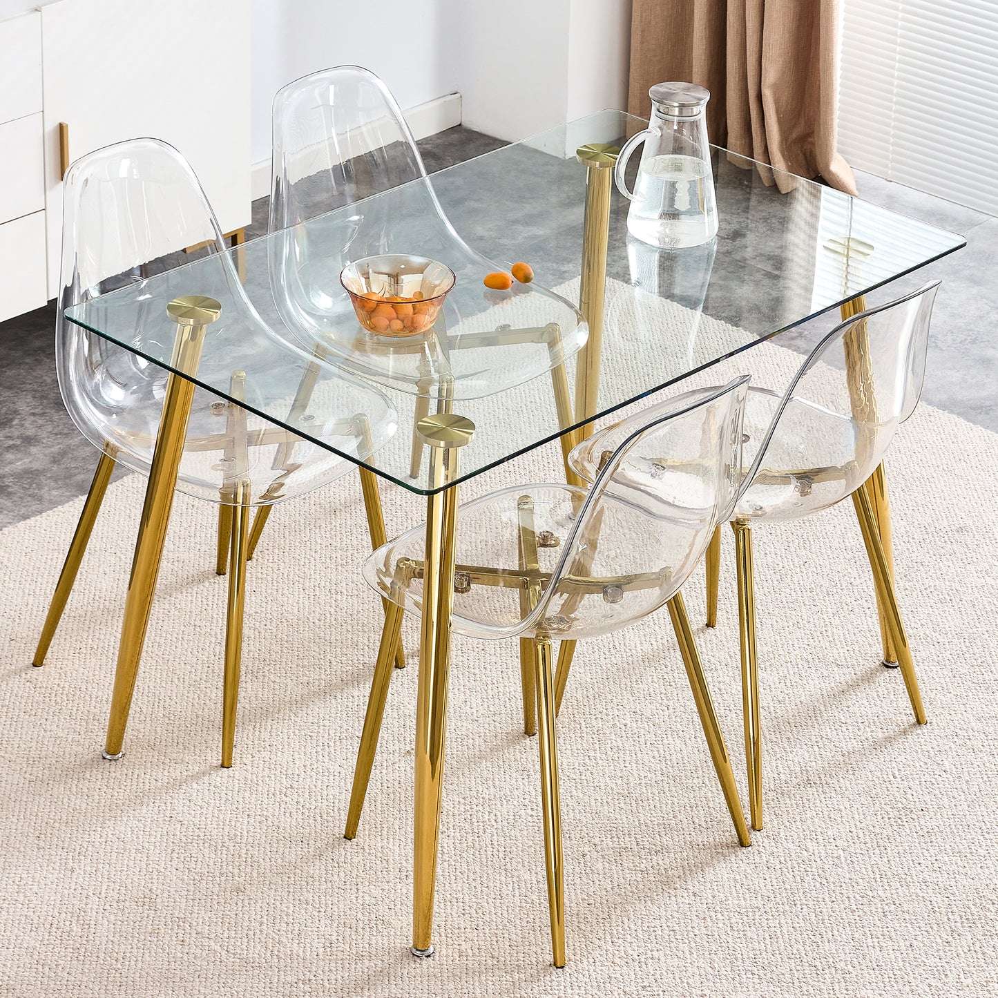 Clear acrylic dining chair with gold legs and glass tabletop