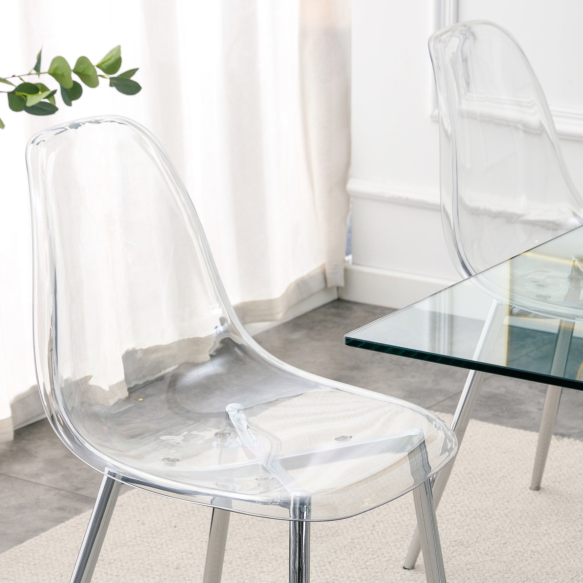 Clear acrylic dining chair with chrome legs and modern design