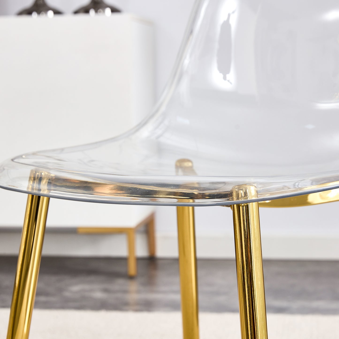 Clear acrylic chair with polished gold legs