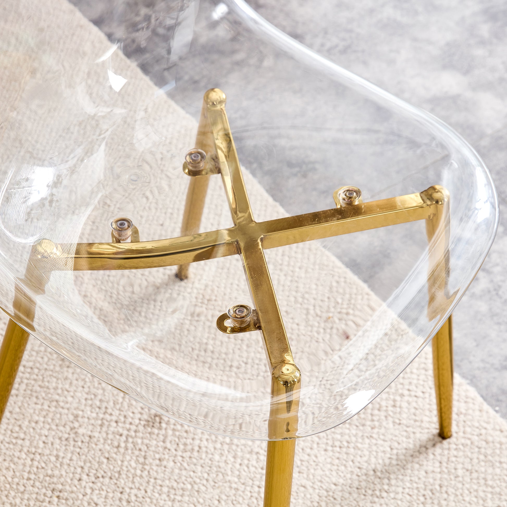 Clear acrylic chair with polished brass legs and crossbrace detail