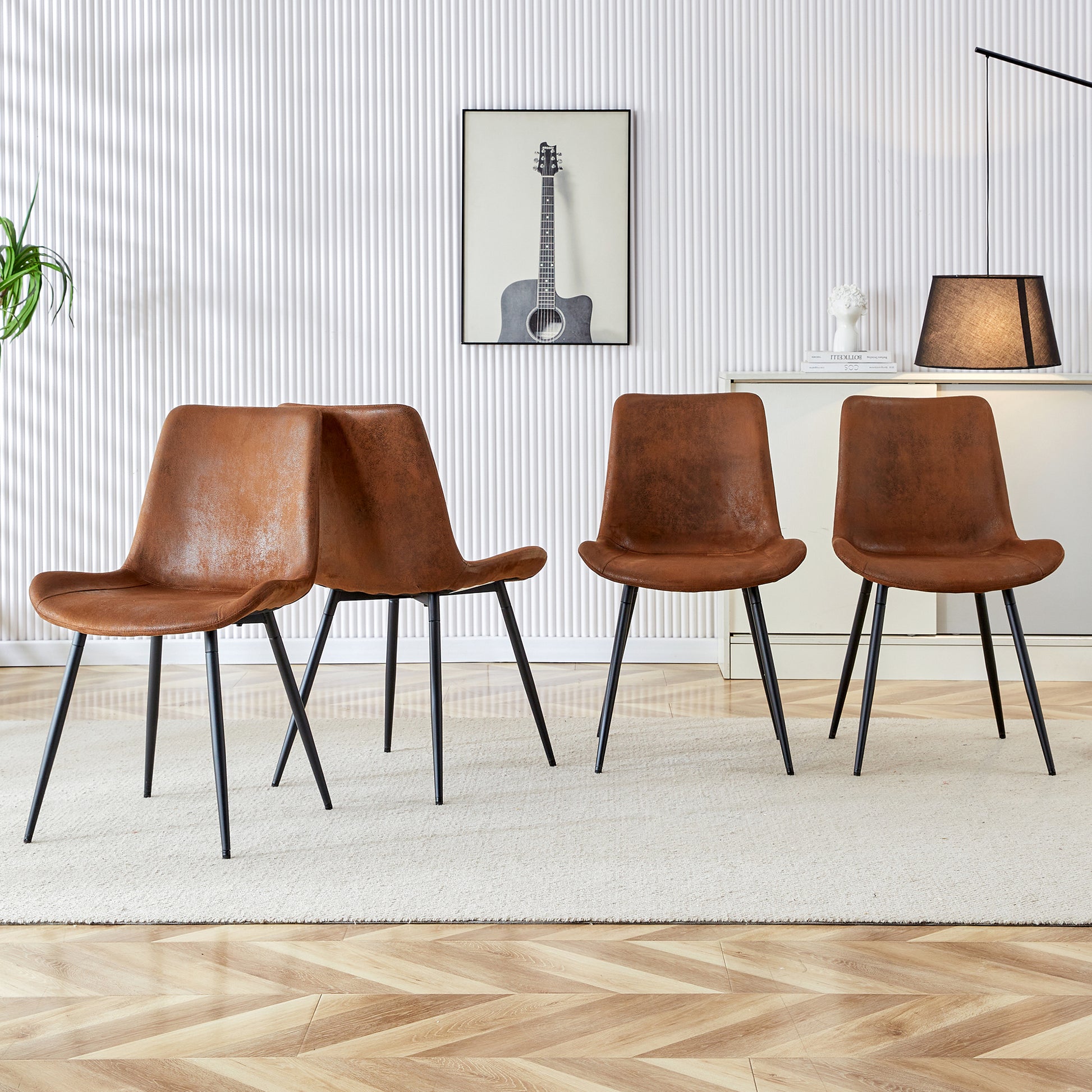 Set of four brown faux leather dining chairs with black metal legs