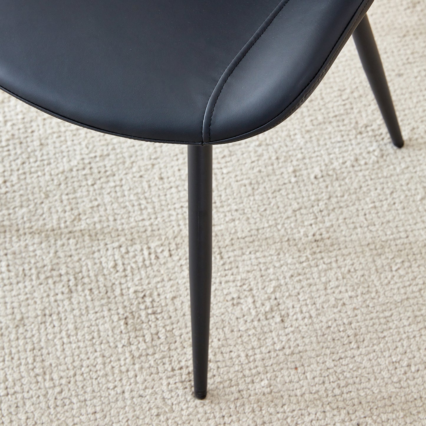 Black faux leather dining chair seat with subtle stitching detail