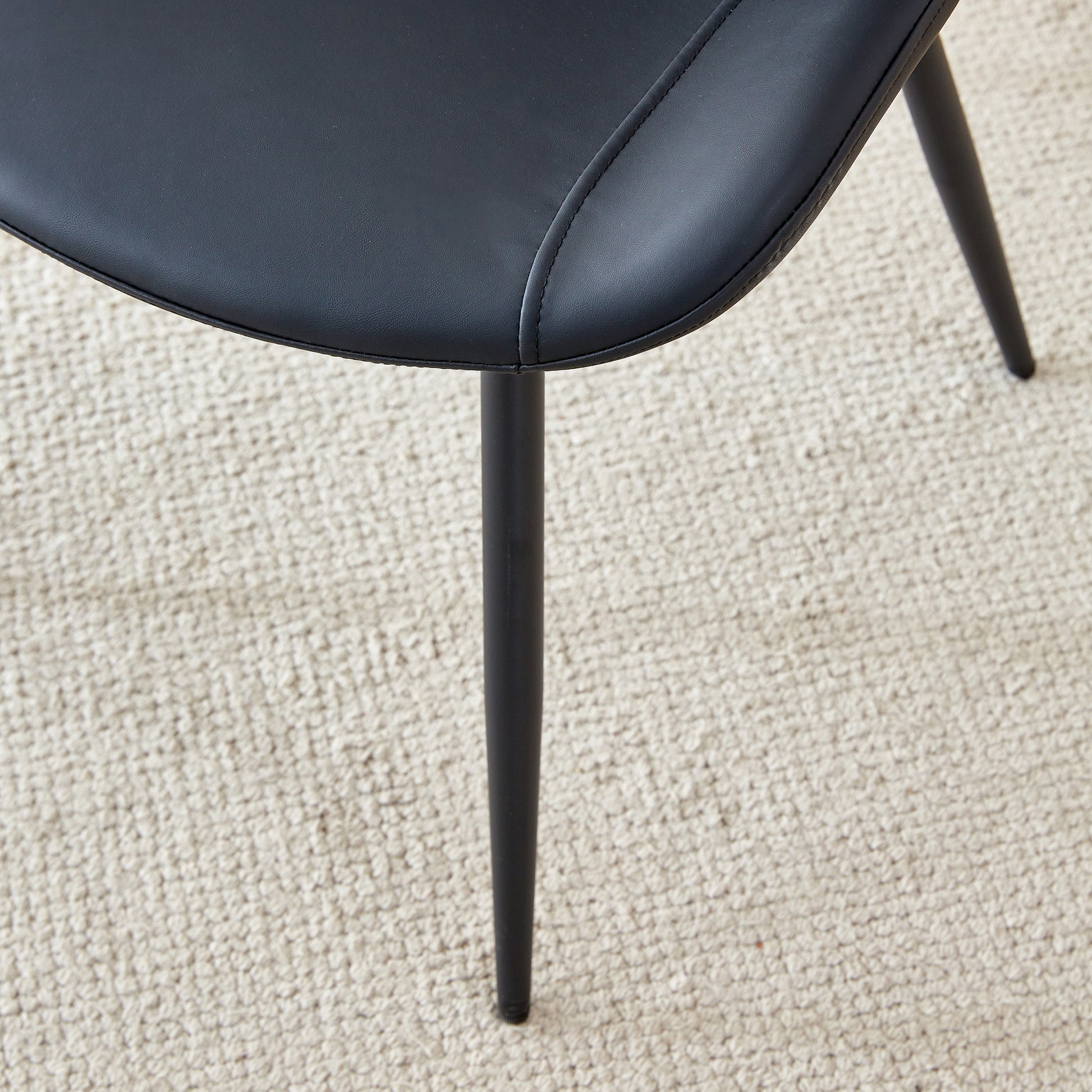 Black faux leather dining chair seat with subtle stitching detail