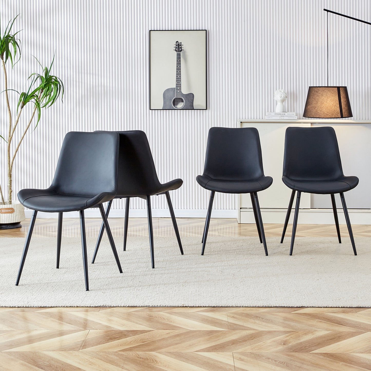 Modern black faux leather dining chairs with slim metal legs