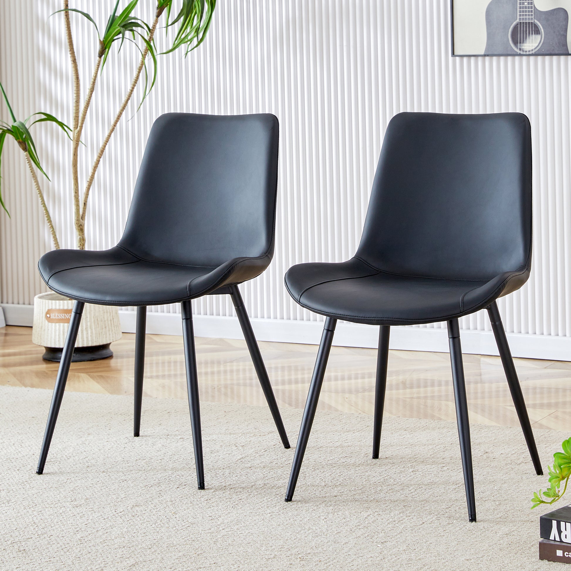 Black faux leather dining chair with curved back