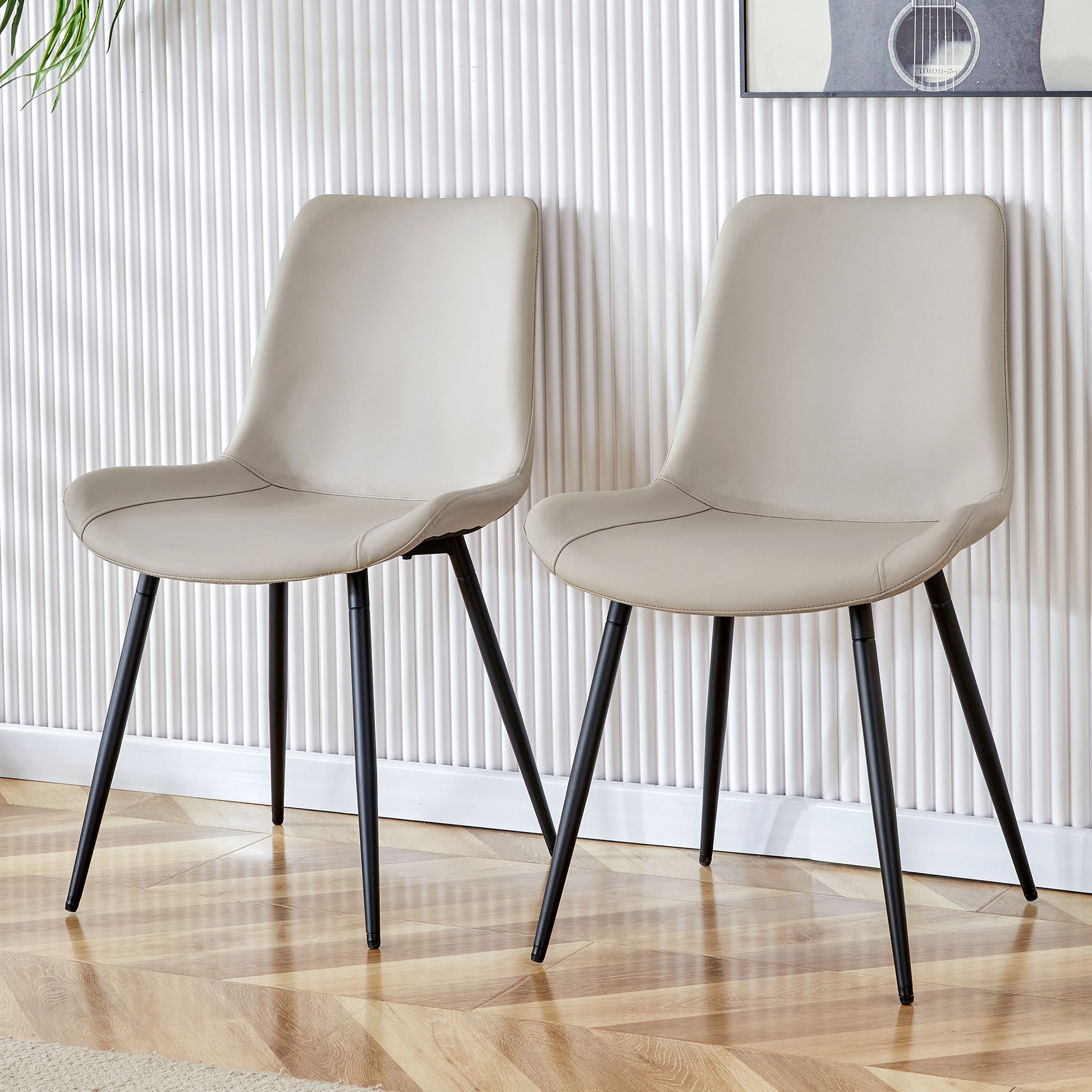 Beige faux leather dining chair with black metal legs